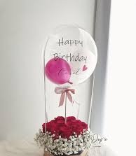 15 Red roses basket with single pink balloon inside a Printed Happy Birthday transparent Balloon