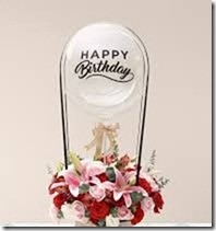 4 Pink Lilies and 10 red carnations tied to a hot air balloon with print happy birthday