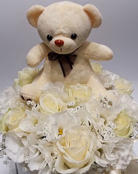 Brown 6 inches Teddy bear with a basket of 20 white roses and white gerberas