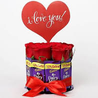 6 Red Roses Teddy 10 dairy milk Chocolates Gift wrapped in a round circle with Red ribbon with a Valentine Heart