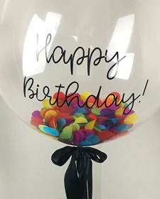 Single happy birthday print on Bubble balloon with colored confetti inside on a stick with Black ribbons