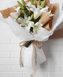 4 White Lilies Bouquet in brown paper wrapping
